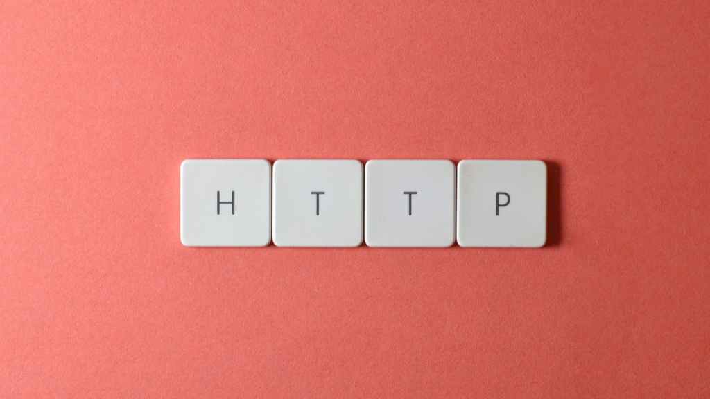Wood tiles with letters stamped into them spelling "HTTP" on an orange background, representing the concept of minimizing HTTP requests.
