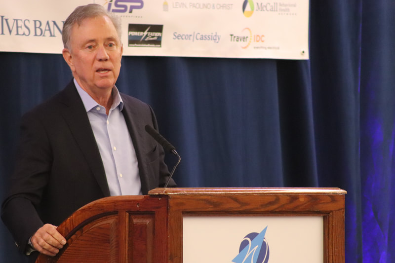 A speaker at a Waterbury Regional Chamber podium